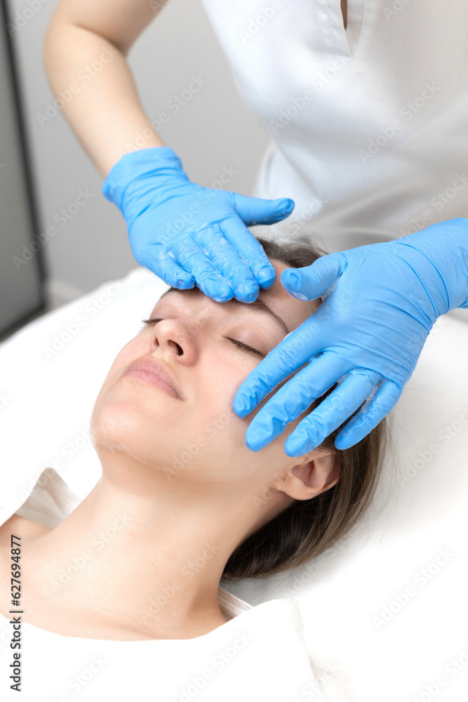 Woman receiving face treatment by cosmetologyst in beauty salon Woman receiving face treatment by cosmetologyst in beauty salon