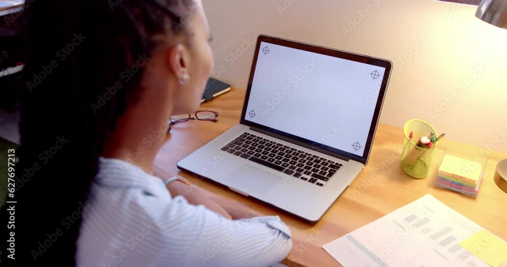 African american casual businesswoman using laptop with copy space on screen in office, slow motion African american casual businesswoman using laptop with copy space on screen in office, slow motion