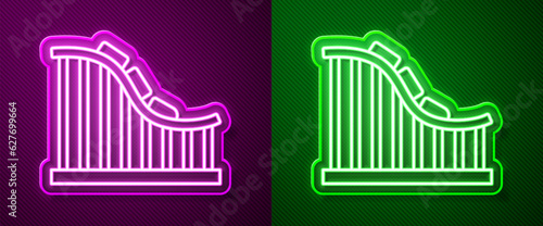 Glowing neon line Roller coaster icon isolated on purple and green background. Amusement park. Childrens entertainment playground, recreation park. Vector