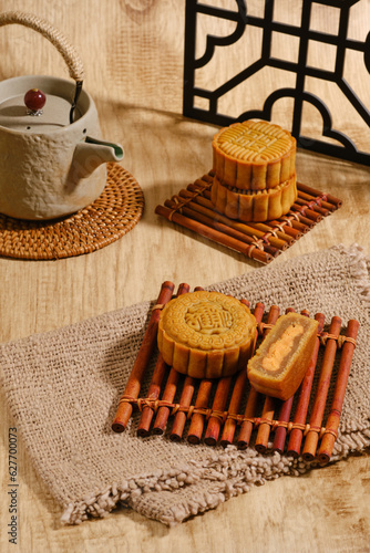 Moon Cake Mid Autumn Festival with teapot on wooden background ,chinese style photograph