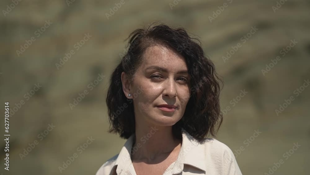 caucasian woman looking at the camera. woman in white casual clothes. slow motion video. High quality Full HD video recording