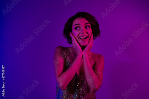 Photo of positive cheerful lady enjoy night club offer advert look empty space isolated neon effect color background