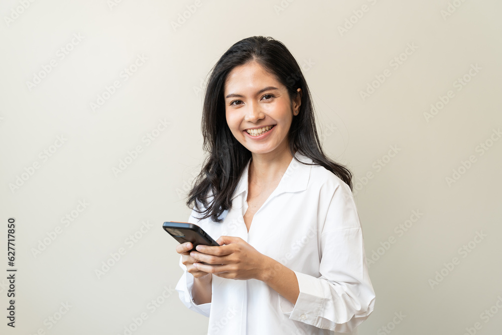 Happy Asian woman holding a smartphone and winning the prize. Happy Asian woman holding a smartphone and winning the prize.