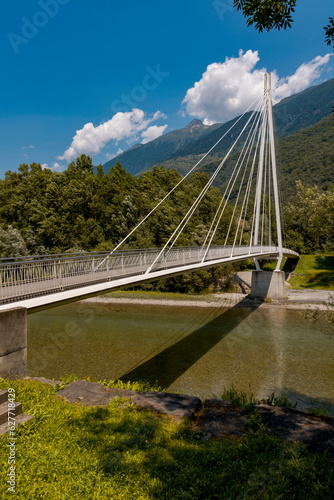 Modern pedestrian bridge in the middle of the mountains of Italian Switzerland, which allows you to cross the Ticino river.