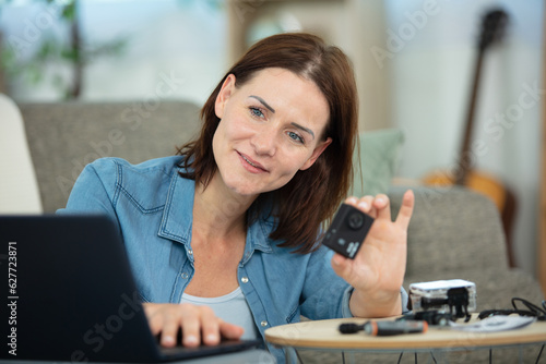 woman is transferring photos from camera