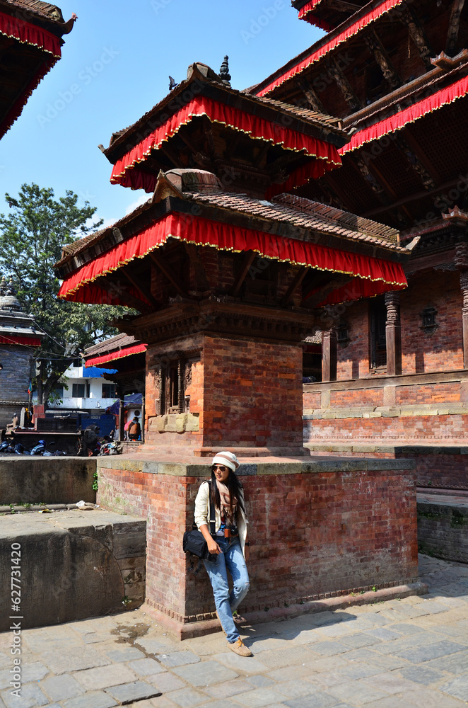 Travelers thai women journey travel visit and take photo with ancient nepalese building and antique nepali architecture in Basantapur durbar square at Katmandu valley hill city in Kathmandu, Nepal