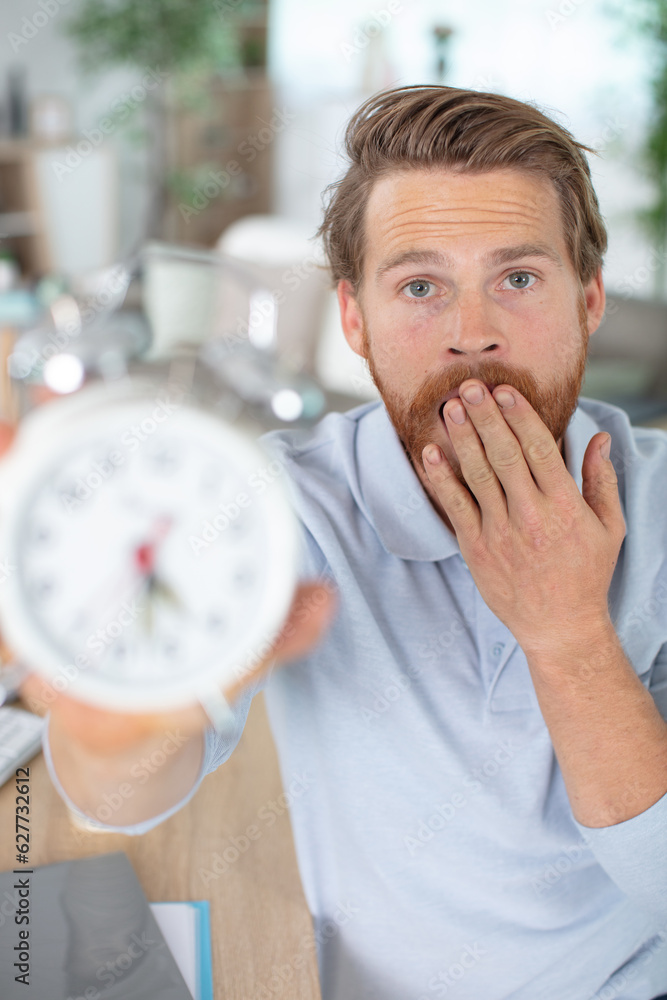 picture of young yawning man showing alarm to camera picture of young yawning man showing alarm to camera