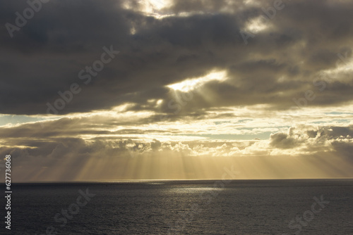 sunset over the sea with light rays