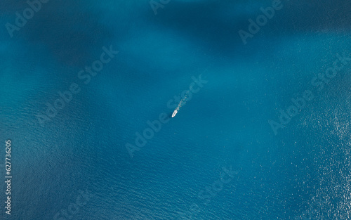 Aerial view of boat crossing the ocean