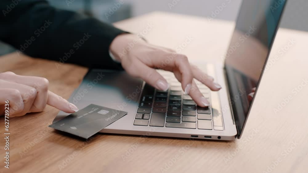 Female hands of cardholder holding credit card making e bank online payment Female hands of cardholder holding credit card making e bank online payment
