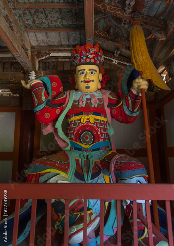 Colorful statue of damun-cheonwang heavenly king of the North at the Pohyon-sa Korean buddhist temple, North Pyongan Province, Myohyang-san, North Korea photo