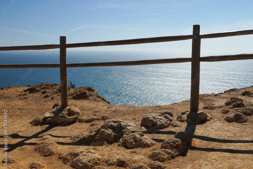 Obraz premium thin fence on a cliff near the ocean or sea. High quality photo