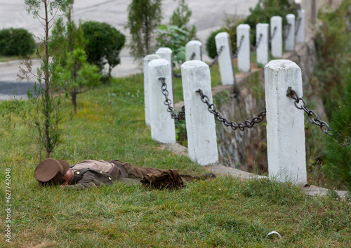 North Korean soldier resting in the grass alongside a country road, Kangwon Province, Wonsan, North Korea photo