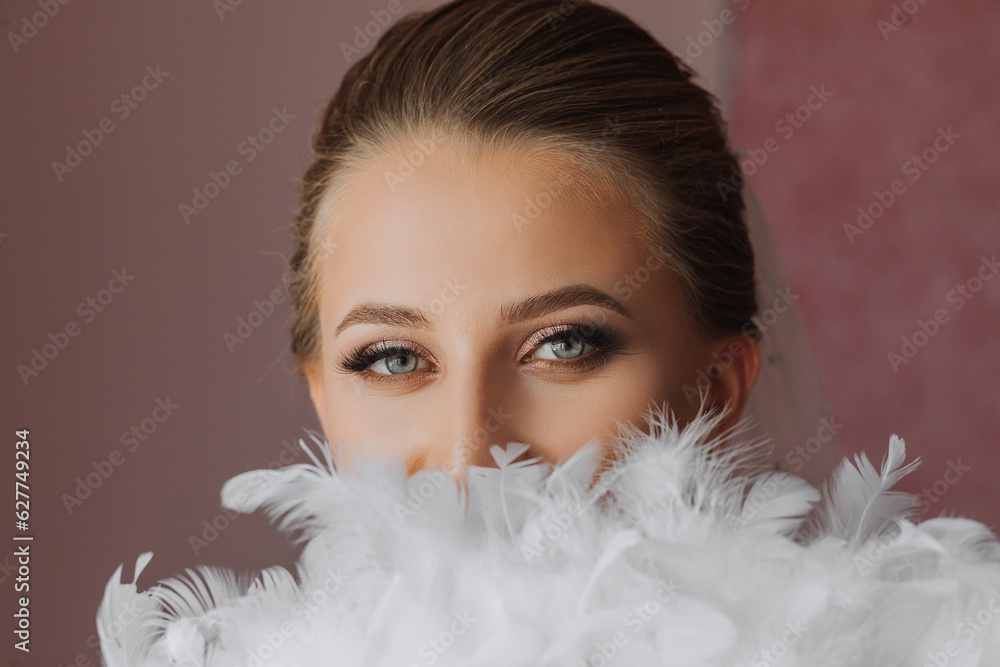 portrait of a beautiful girl in a wedding dress. Fashion, glamour, concepts. The morning of the bride, the bride dresses and prepares for the wedding ceremony portrait of a beautiful girl in a wedding dress. Fashion, glamour, concepts. The morning of the bride, the bride dresses and prepares for the wedding ceremony