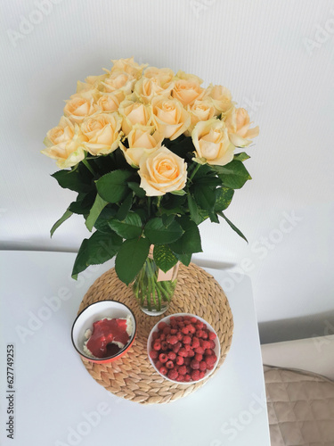 Still life with a bouquet of roses and breakfast food. Festive table setting.