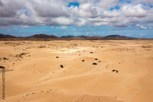 Sand dunes in Las Dunas de Corralejo  Corralejo Natural Park  dramatic cloud formation  Fuerteventura  Canary Islands  Spain. Sand dunes landscape  Corralejo  Fuerteventura  Canary Islands  Spain.
