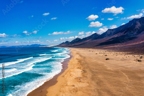 Amazing Cofete beach with endless horizon. Volcanic hills in the background a...