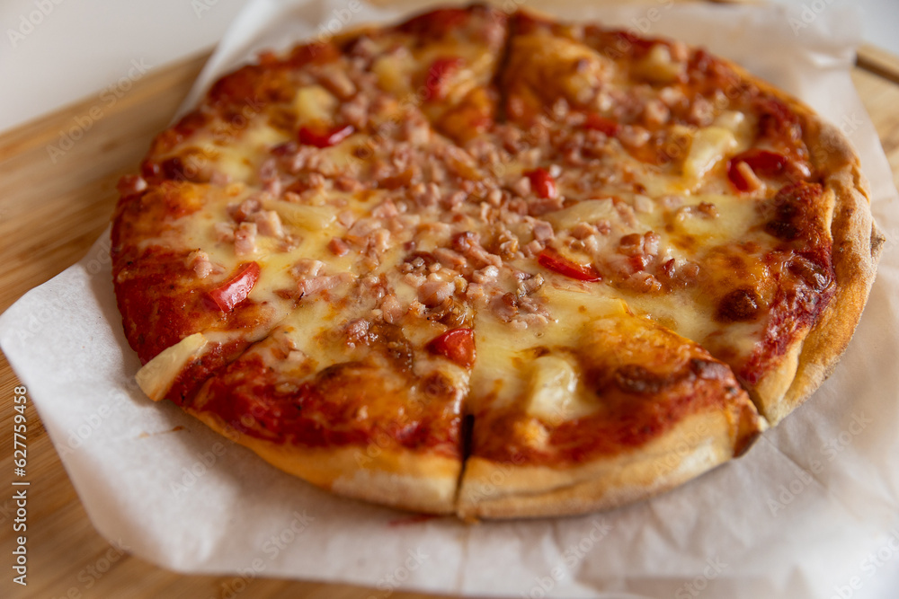 pizza with pineapple, ham and cheese