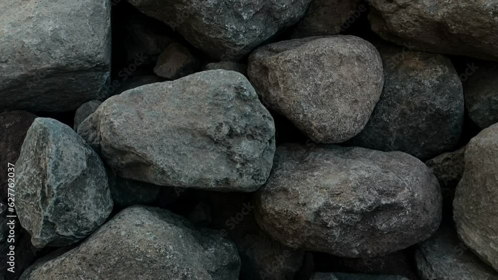 Slow motion video of large gray stones. The texture of the boulders is a top view Slow motion video of large gray stones. The texture of the boulders is a top view