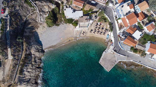 Lovely greek fisher town of Armenistis in a quiet summer morning. Port with local beach in transparent clear water at Ikaria  Greece