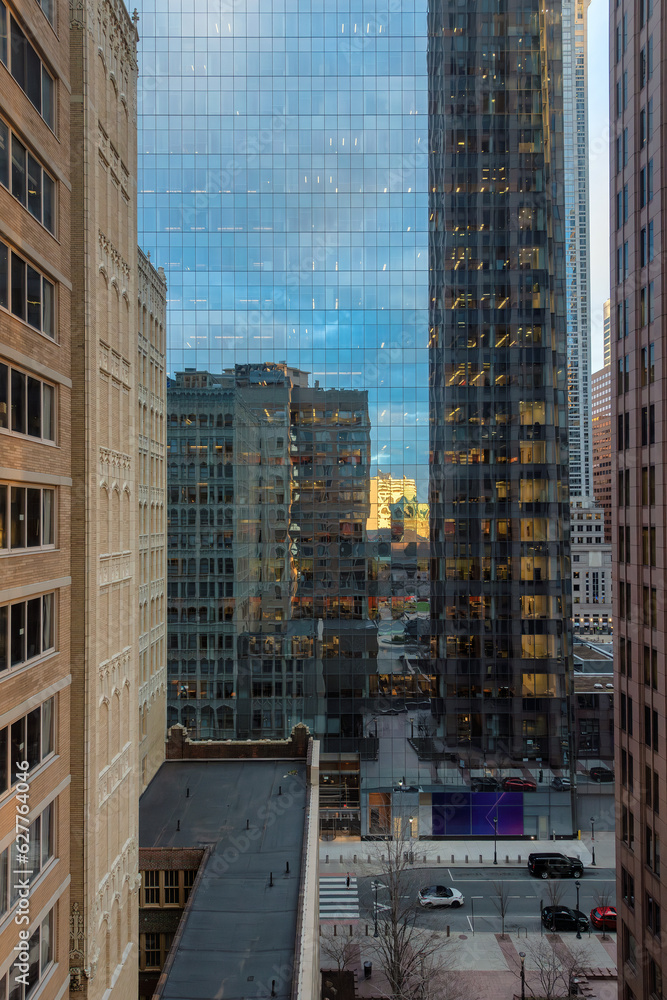 Fototapeta premium Beautiful reflections of buildings in the glass walls of skyscrapers at sunset in downtown of Philadelphia, Pennsylvania, USA.