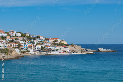 Lovely greek fisher town of Armenistis in a quiet summer morning. Port with local beach in transparent clear water at Ikaria, Greece © Pablo