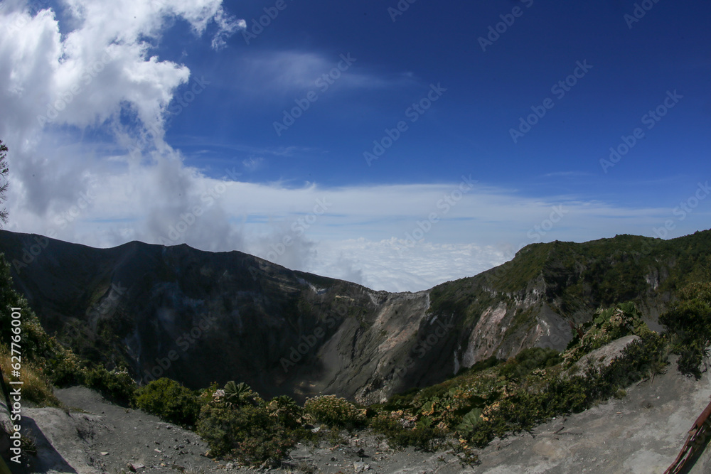 Volcanic landscape on the top of the crater with clouds at the Irazú Volcano National Park