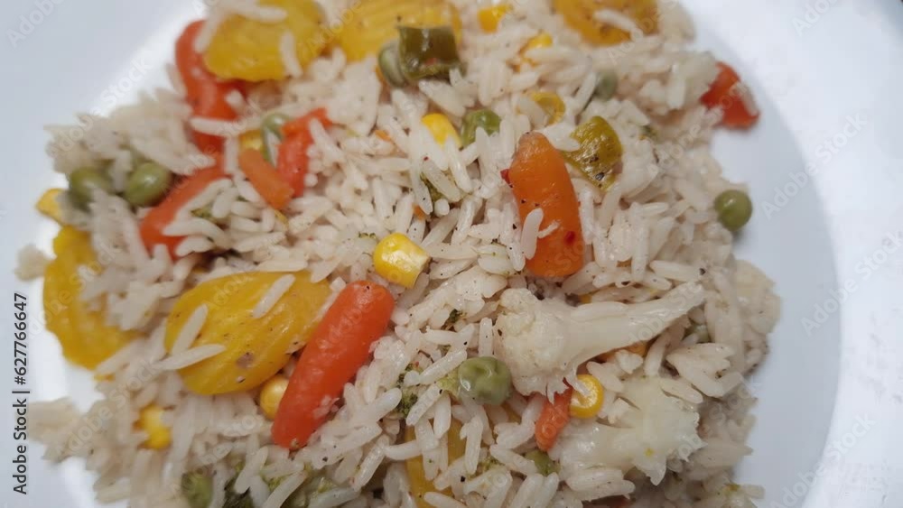 Rice boiled with vegetables on the white dish, top view Rice boiled with vegetables on the white dish, top view