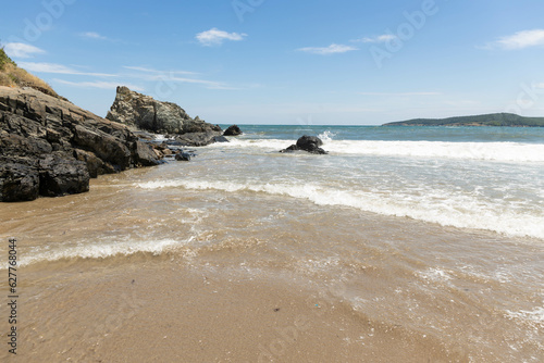 Vacation in summer. empty beach, rocks and waves in the sea © Andon