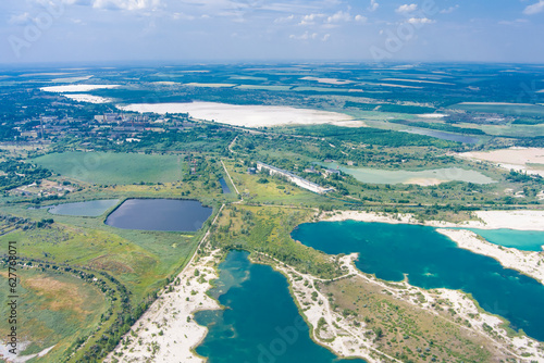 Top view of flooded quarries with white quartz sand. Beautiful artificial lakes with blue water