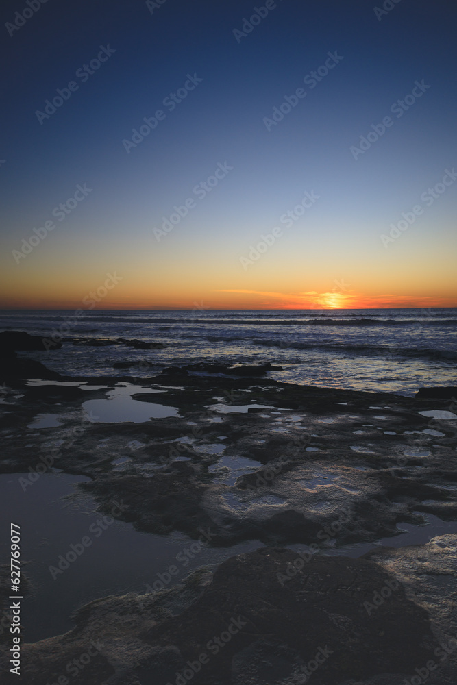 Sunset over tidepools at beach in San Diego California