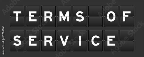 Black color analog flip board with word terms of service on gray background