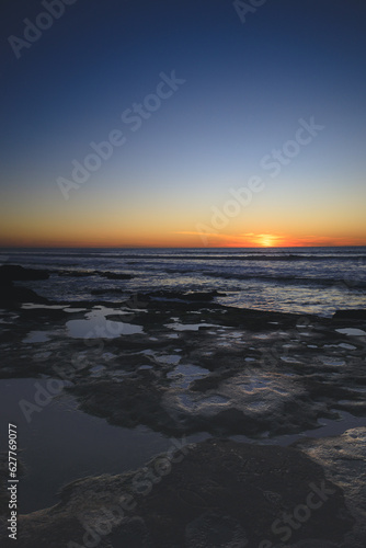 Sunset over tidepools at beach in San Diego California