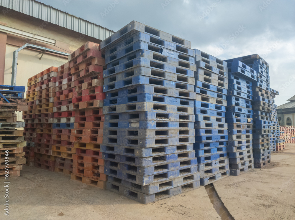 pile of dirty plastic pallets, concept photo of bankruptcy service cargo transportation industry service pile of dirty plastic pallets, concept photo of bankruptcy service cargo transportation industry service