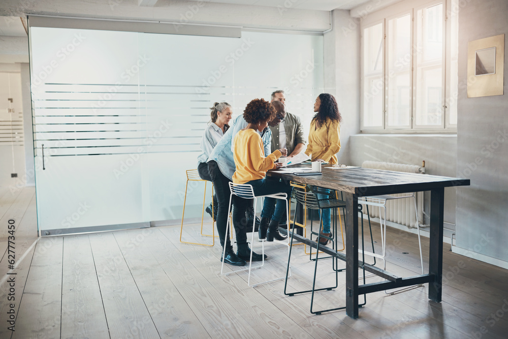 Diverse businesspeople working together around an office table Diverse businesspeople working together around an office table