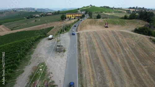 Europe, Italy , Montalto Pavese Oltrepo' - historical antique vintage Fiat cars cross the hills and the wine road - aerial drone view of vintage cars on parade photo