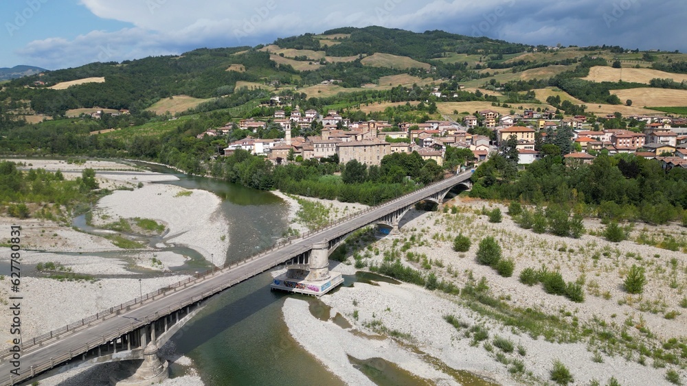 Europe, Italy , Emilia Romagna , drone aerial view of Travo village with bridge on the river in Val Trebbia Bobbio - drought and aridity during summer water emergency - Climate change global warming  