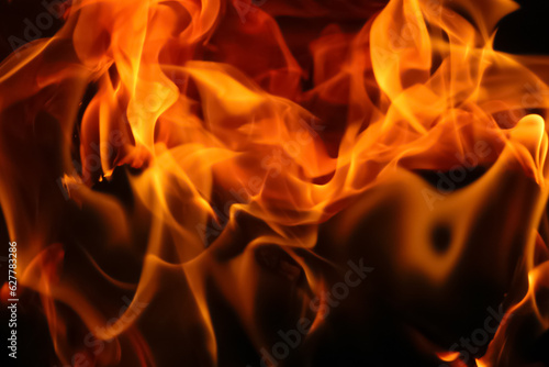 Fiery flames on a dark backdrop create a captivating abstract texture, perfect for banners. The blazing fire adds a touch of intensity and drama to the background
