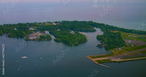 Plane lands at Billy Bishop Toronto City Airport on runway. Slow motion of amazing view from the top to Billy Bishop Toronto City Airport. Enjoy wonderful view to airport and watch how plane lands.