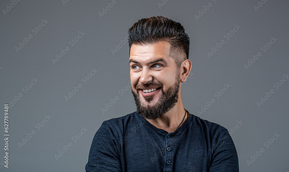 Fototapeta premium Side view portrait of stylish man. Perfect beard. Bearded man, stylish hairstyle, beard isolated on gray background. Man's haircut in barber shop. Smiling man portrait isolated. People, male beauty