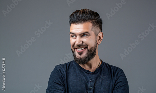 Side view portrait of stylish man. Perfect beard. Bearded man, stylish hairstyle, beard isolated on gray background. Man's haircut in barber shop. Smiling man portrait isolated. People, male beauty © Yevhen