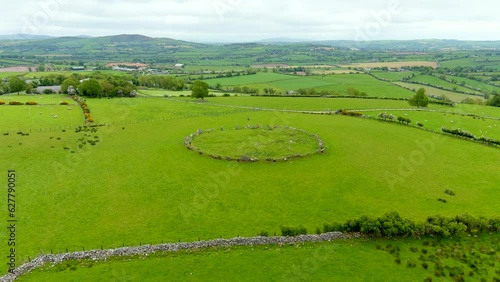 Aerial view of female tourist exploring the famous Beltany stone circle, Ireland photo