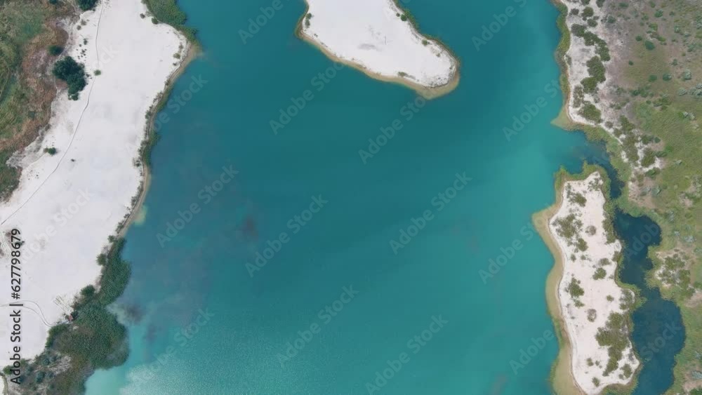 Top view of flooded white quartz sand quarries (camera moves forward). Beautiful artificial lakes with blue water Top view of flooded white quartz sand quarries (camera moves forward). Beautiful artificial lakes with blue water