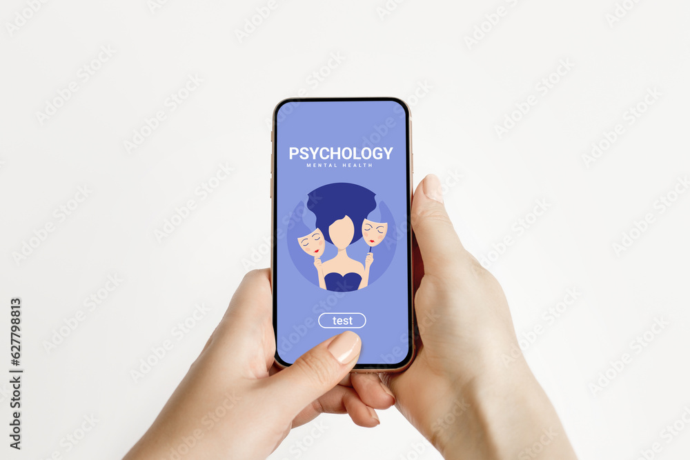 Bipolar disorder concept. Female hands hold a phone with a mobile application on psychology