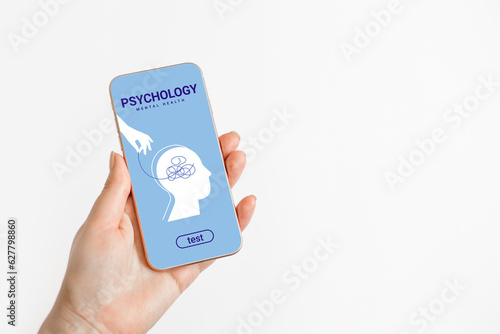Psychotherapy, mental health concept. Female hands hold a phone with a mobile application on psychology