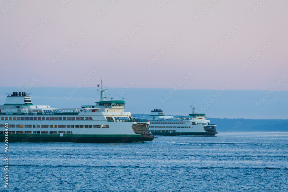 Ferry Boats Cross Paths On the Way to Seattle and Bainbridge Island, Washington. Commuters and visitors ride the super ferry on its hourly run across Elliott Bay to the Kitsap Peninsula.