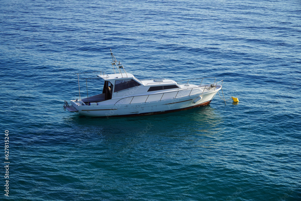 Fototapeta premium white boat in blue water