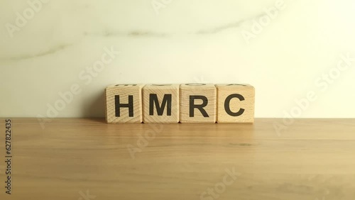 HMRC abbreviation from wooden blocks. Her Majestys Revenue and Customs UK tax authority concept photo