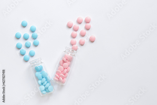 Complex of vitamins of group B, tablets, dietary supplement. A set of blue and pink pills in glass bottles on a white background. Health care and painkillers and pills. Pharmacy medicines