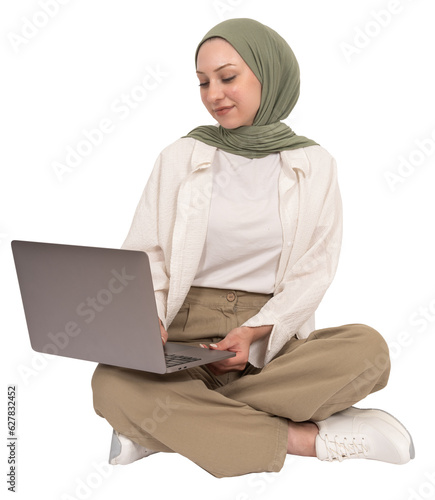 Bild auf Leinwand Using laptop, young caucasian university student muslim girl in hijab using laptop